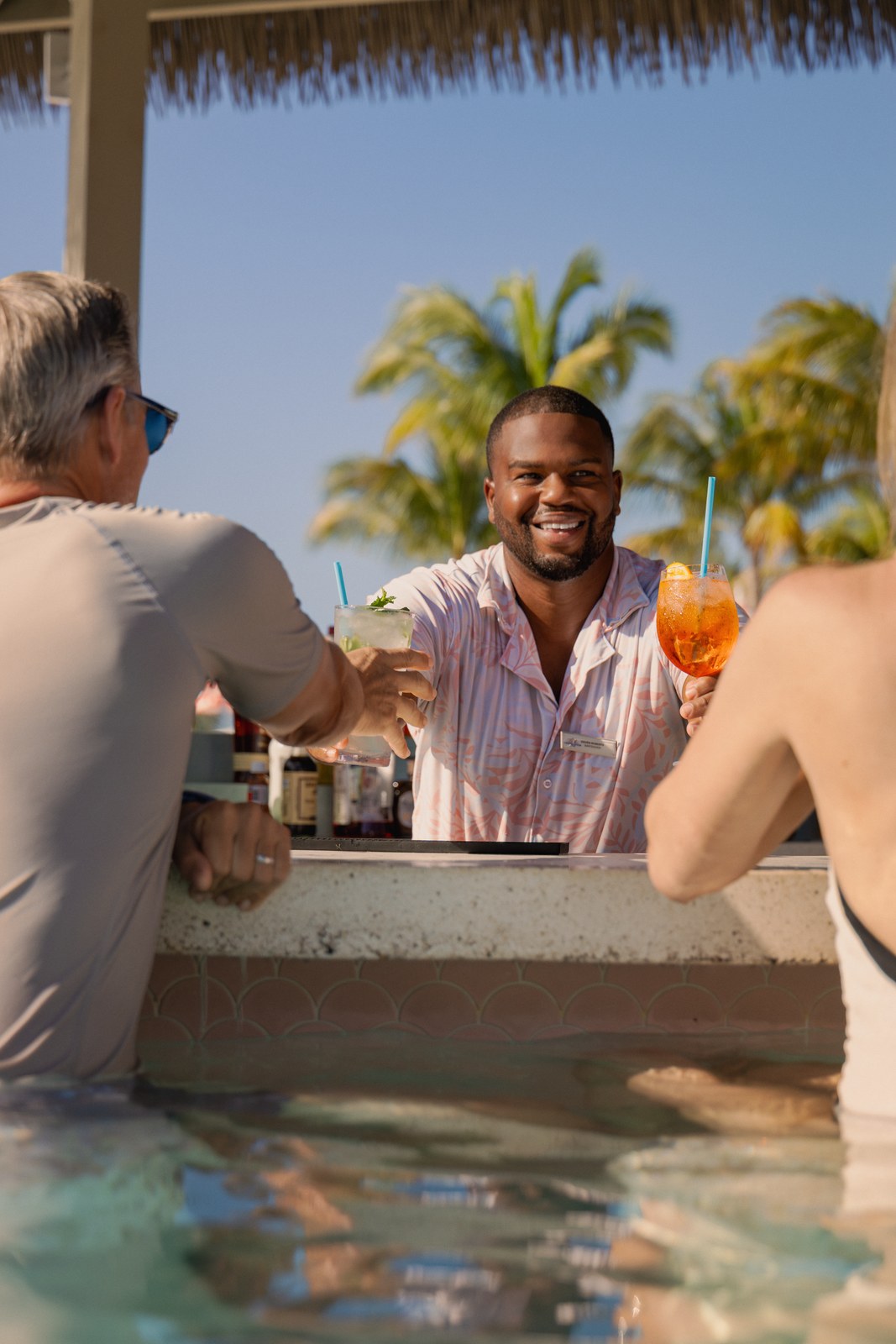 Celebration Key for Princess: a bartender serving guests at the Pearl Cove swim-up bar